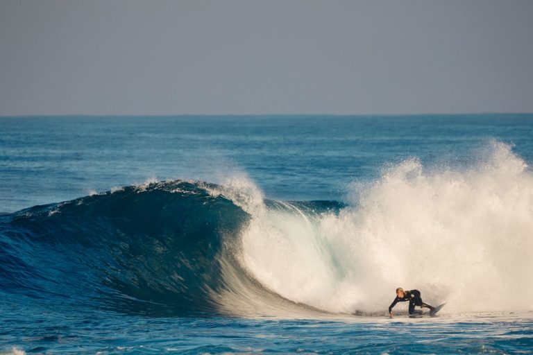 A surfer navigates a tricky wave in Margaret River to show the outdoor adventure on this south west australia road trip