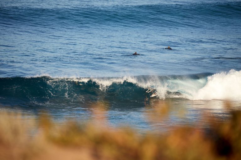 Surfers wait for the next world class wave in the ocean while on the south western australia road trip route