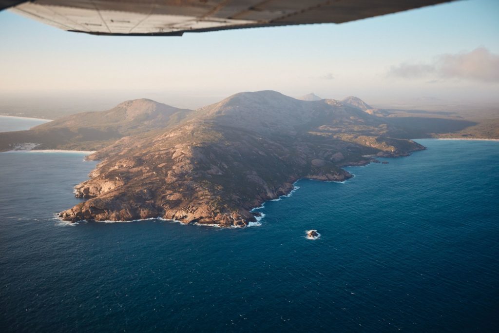 An aerial image taken out of a plane of the rugged cliff coastline in Esperance to show the immense natural landscape on the perth to esperance road trip The Edge