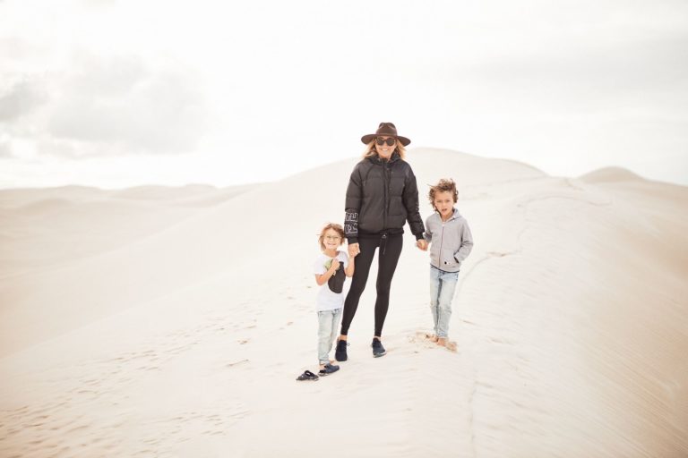 A mother and two kids stand at Esperance Sand Dunes to show this is a family friendly perth to esperance road trip