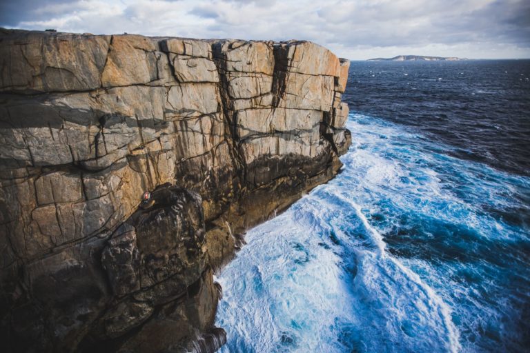 Image to depict the view from The Gap and Natural Bridge viewing platform in Albany. Shows rocky cliff and blue surging Southern Ocean