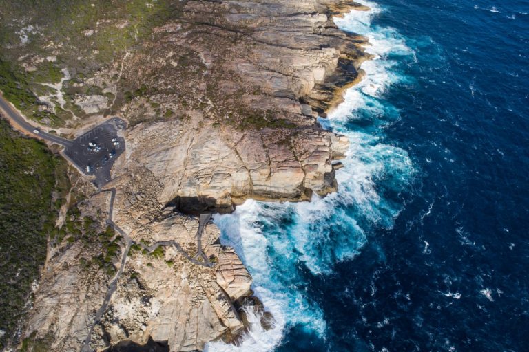A drone image of Albany coastline where a viewing platform overhangs the Southern Ocean