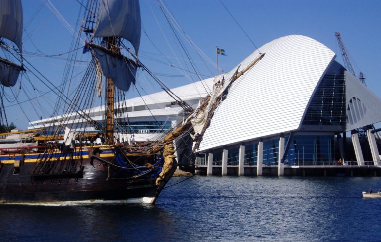 A landscape image of an old ship replica with a modern museum in the background to show cultural and historical experiences on The South West Edge road trip