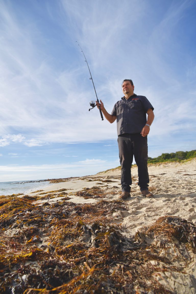 Portrait image of a local Indigenous man fishing in Margaret River region to show cultural experiences along The South West Edge road trip