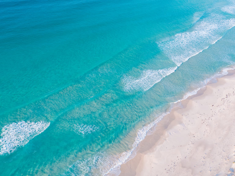 drone image of pristine blue waters and white sand to show beaches on the south west edge road trip