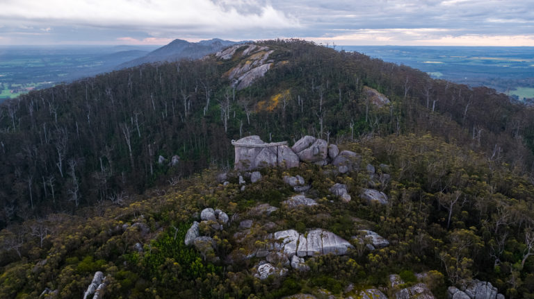 far away drone image of granite rock with metal infrastructure and sweeping views to show epic adventure on the south west edge