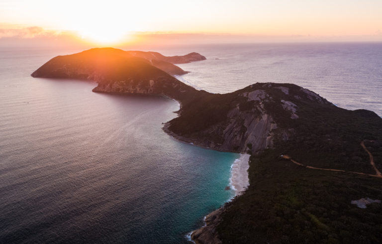 a drone image of a peninsula rugged coast at sunset to show epic coastal spots along The South West Edge