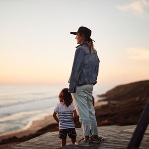 A mother and son gaze out at an ocean view to show sights along this road trip down south western australia
