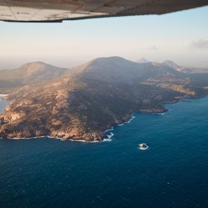 An aerial image taken out of a plane of the rugged cliff coastline in Esperance to show the immense natural landscape on the perth to esperance road trip The Edge