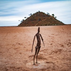 An image of a metal art sculpture on red dirt sand in the outback to show unique art and natural landscapes on The South West Edge perth to esperance road trip